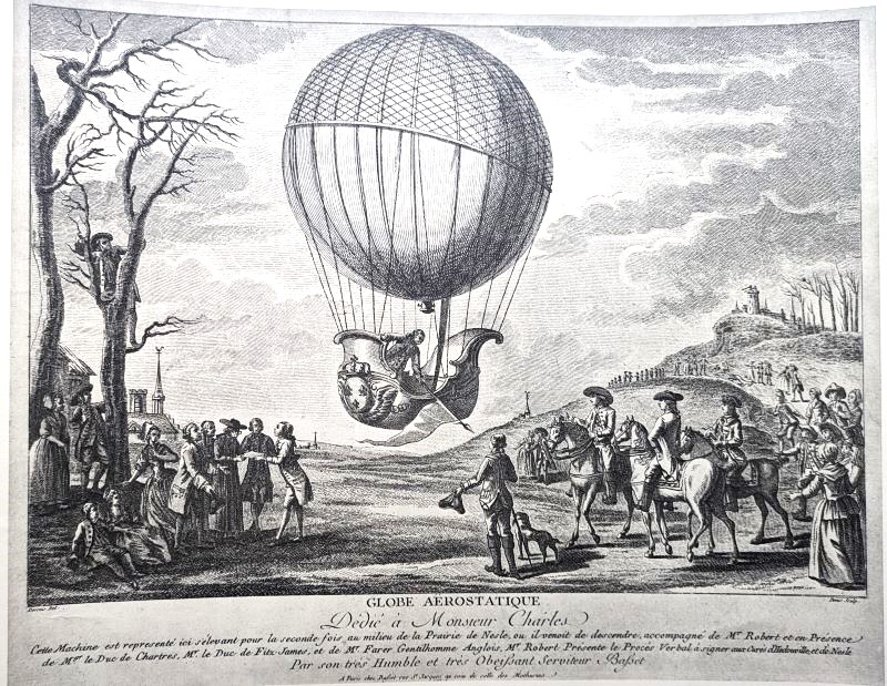 Black and white image showing Professor Charles just airborne in his balloon standing in a boat shaped basket with many onlookers, three on horseback.